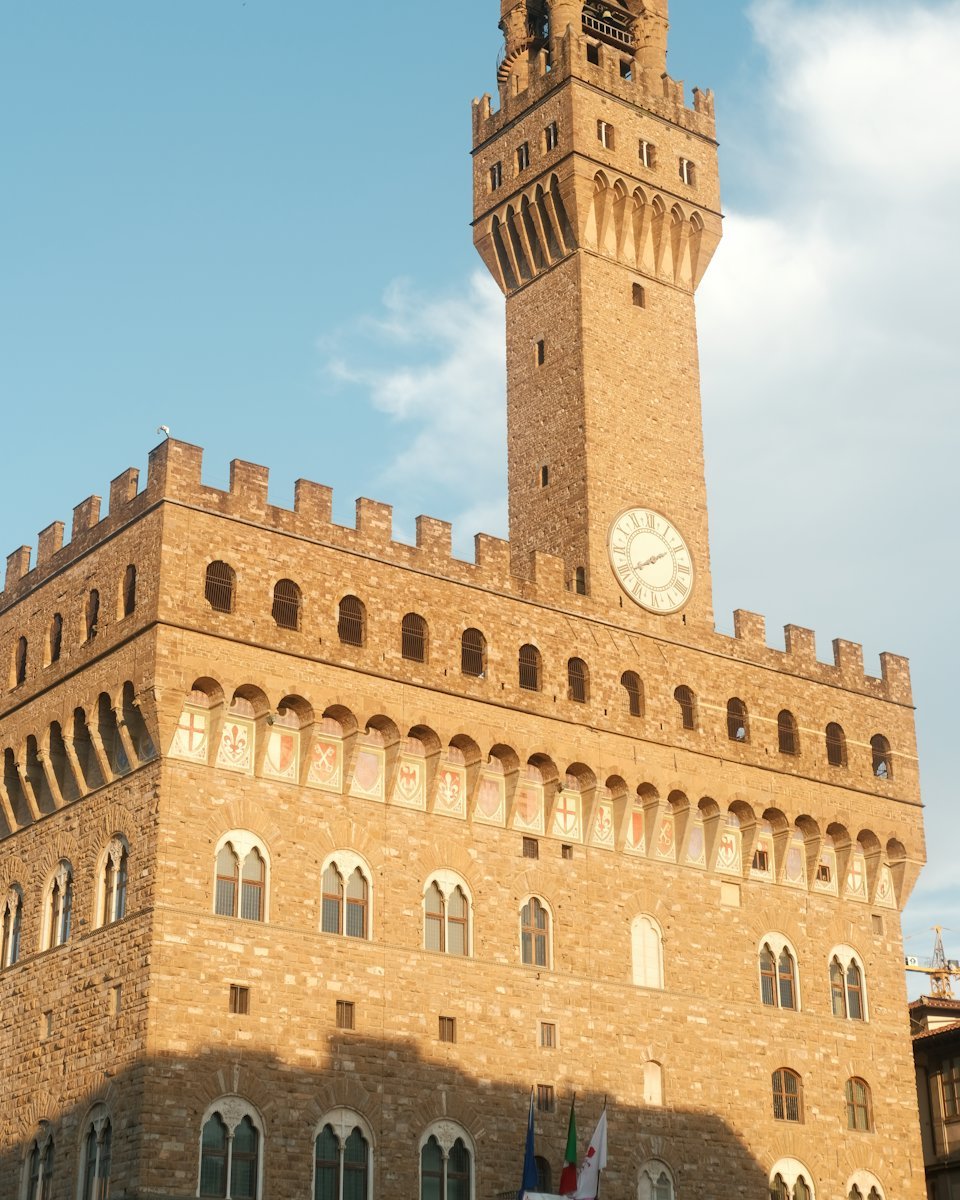 Palazzo Vecchio and its stone tower against a blue sky