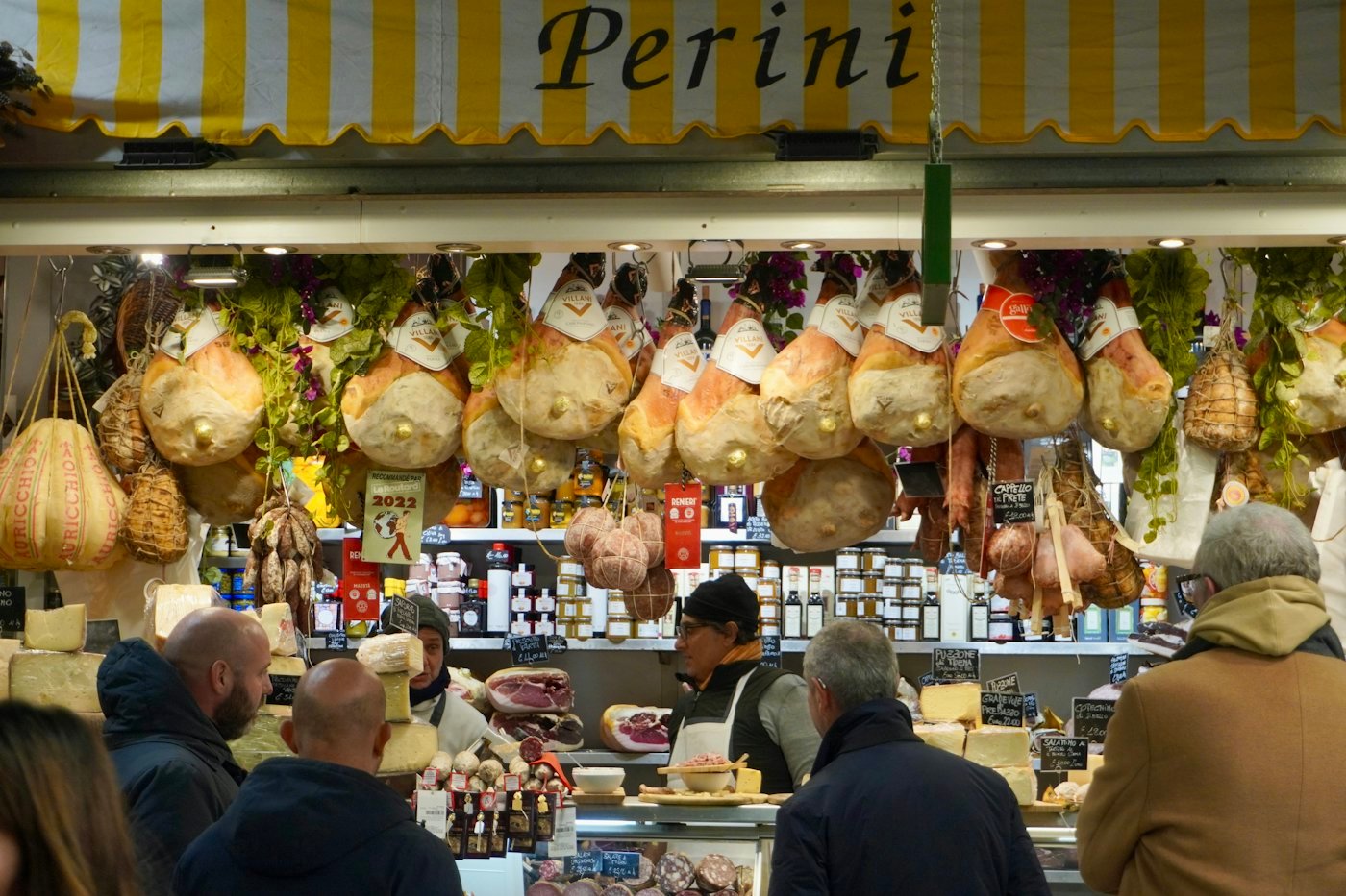 Hams and local cheeses at a food stall in the Mercato Centrale