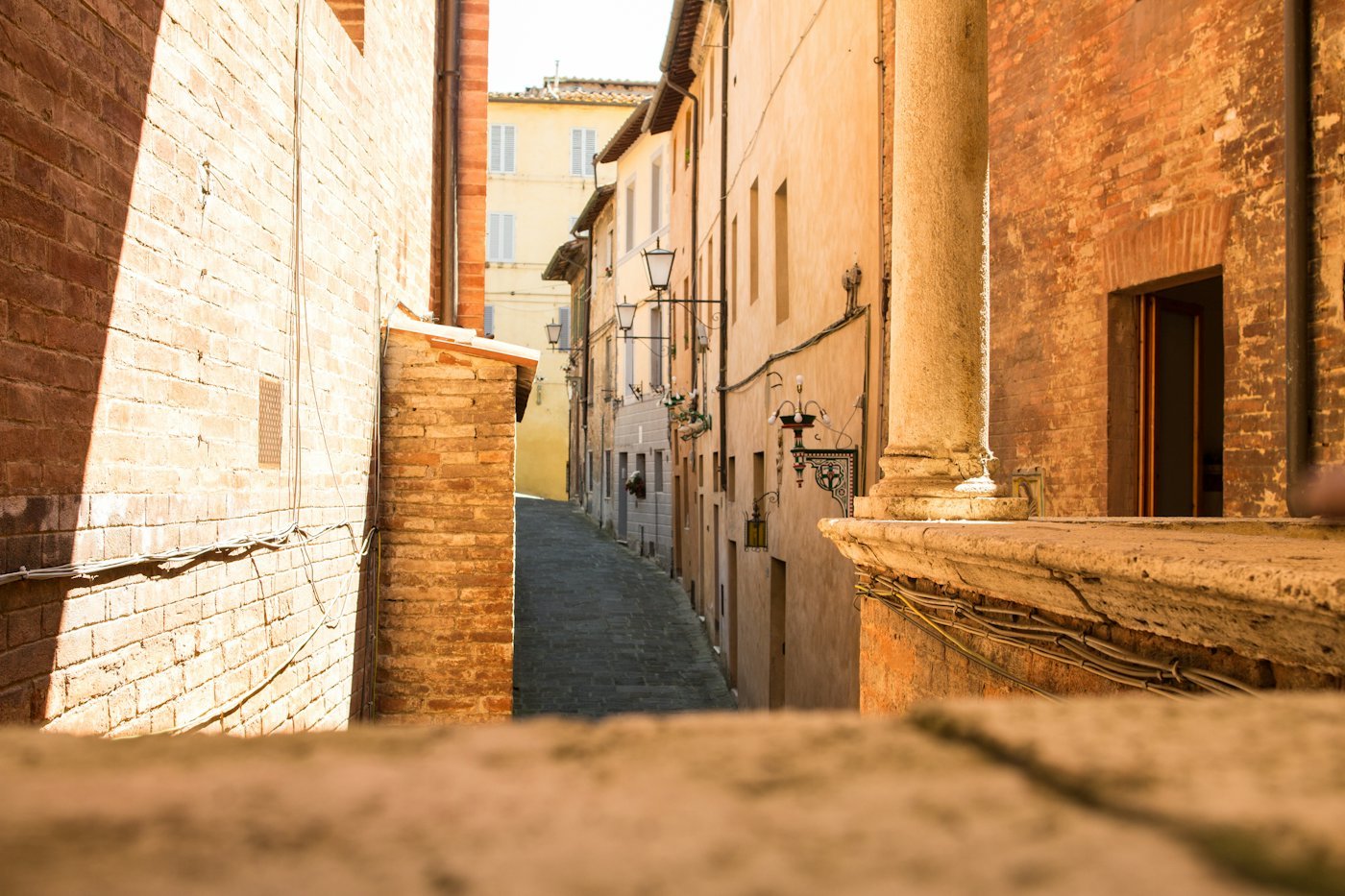 A narrow, quiet lane between old brick buildings