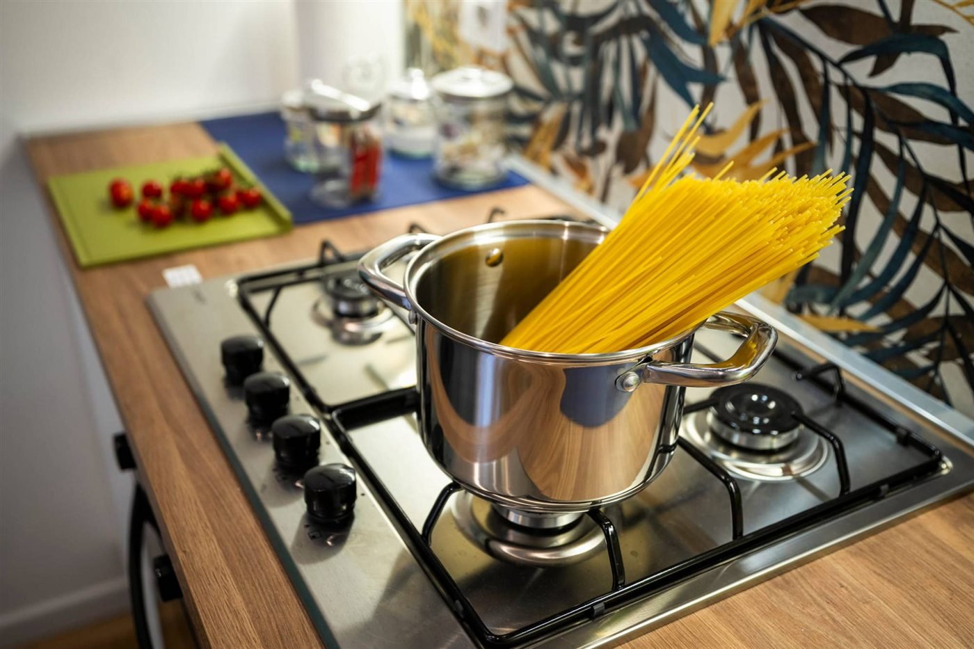 Spaghetti ready to cook on the stove of an apartment kitchen